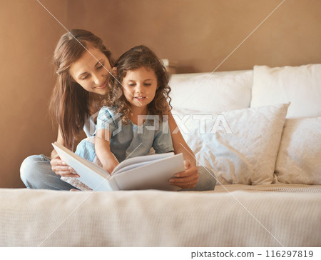 Girl, mom and happy with reading on bed with care, bonding and love with connection for learning in house. Storytelling, mother and daughter with book listening or teaching in bedroom at family home Girl, mom and happy with reading on bed with care, bonding and love with connection for learning in house. Storytelling, mother and daughter with book listening or teaching in bedroom at family home 116297819