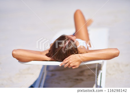 Woman, back view and relax on chair at beach for adventure, holiday or sunshine at tropical resort in Maldives. Female person, island and travel on vacation, peace or blue sky for bikini sunbathing 116298142