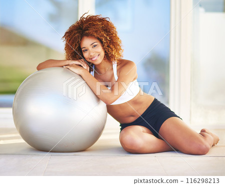 Girl, smile and confident in home with medicine ball for exercise, workout and satisfied with progress. Female person, pilates break and happy portrait with fitness for health, wellbeing and wellness 116298213