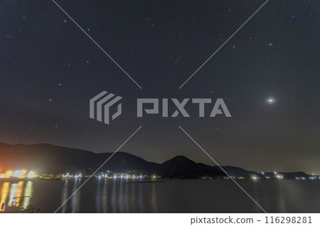 Spring starry sky in Setouchi. The Big Dipper and spring constellations rising in the sky over a fishing port. Spring starry sky in Setouchi. The Big Dipper and spring constellations rising in the sky over a fishing port. 116298281