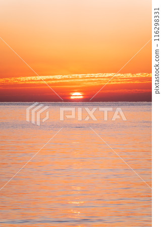 Beautiful red and orange sunrise over the sea. Beautiful red and orange sunrise over the sea. 116298331