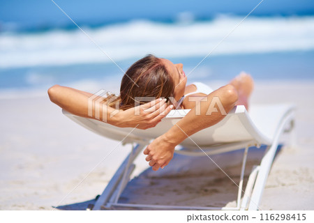 Woman, chair and relax in summer at beach for adventure, holiday or sunshine at tropical resort in Maldives. Female person, back and island travel on vacation, peace or nap for bikini sunbathing 116298415