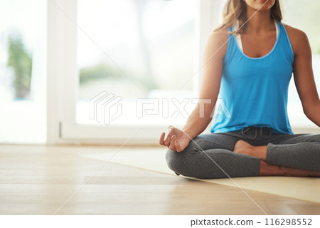 Yoga, lotus meditation and woman in home for health, wellness and mindfulness exercise. Pilates, zen chakra and calm yogi for spiritual fitness, holistic workout or peace in apartment living room 116298552