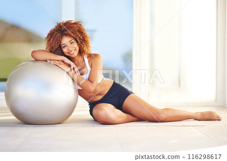 Girl, smile and portrait in home with medicine ball for exercise, workout and satisfied with progress. Female person, break and happy or confident with fitness for health, wellbeing and wellness 116298617