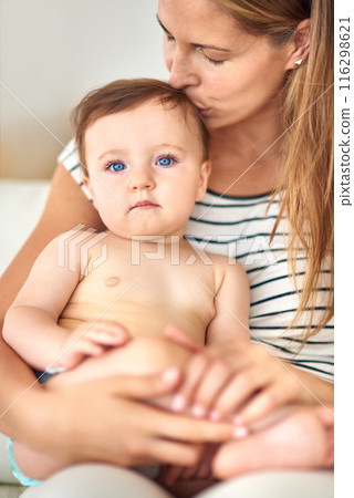 Mom, baby and portrait with head kiss for care or childcare with support, love and cute as toddler for child development. Parent, kid and growth at home for bonding, childhood memories and trust 116298621