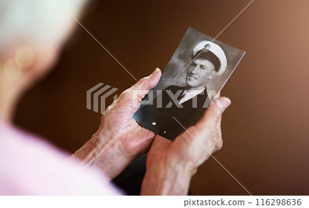 Senior hands, holding and photo of husband for memory with love, remembering and nostalgia. Loss, people and emotional connection in home with self reflection in closeup with vintage picture. Senior hands, holding and photo of husband for memory with love, remembering and nostalgia. Loss, people and emotional connection in home with self reflection in closeup with vintage picture. 116298636