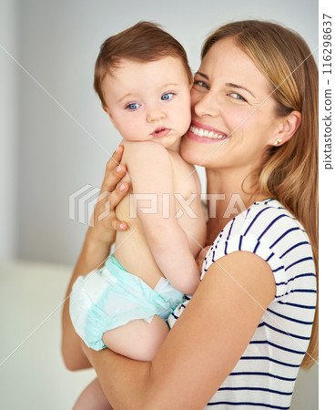 Love, portrait and mother holding baby in diaper at home for safety, happiness and protection. Smile, care and mom with cute boy toddler, kid or child for bonding together at family house in Canada. Love, portrait and mother holding baby in diaper at home for safety, happiness and protection. Smile, care and mom with cute boy toddler, kid or child for bonding together at family house in Canada. 116298637