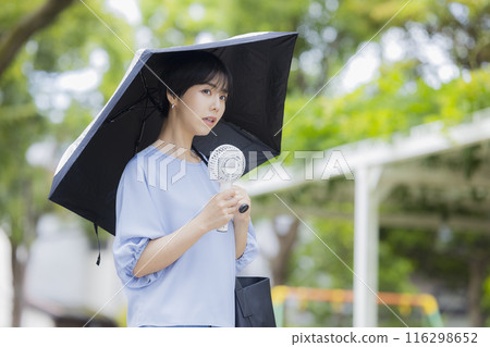 A woman holding a parasol 116298652