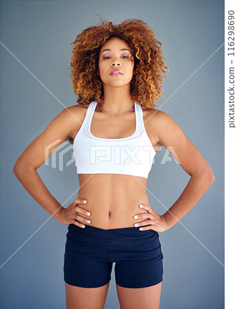 Woman, studio and serious for fitness in portrait, sportswear and confident on gray background. Person, wellness and athlete for results of workout or exercise, tough and proud of transformation Woman, studio and serious for fitness in portrait, sportswear and confident on gray background. Person, wellness and athlete for results of workout or exercise, tough and proud of transformation 116298690
