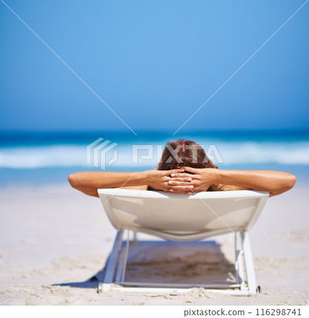 Back view, woman and relax on chair at beach for adventure, holiday or sunshine at tropical resort in Maldives. Female person, island and travel on vacation, peace or blue sky for sunbathing 116298741
