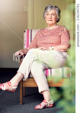 Senior woman, relax and thinking on chair in home for retirement, memory and nostalgia. Female person, thoughtful and calm in seat for remembering history, past experiences and contemplating pension 116298762