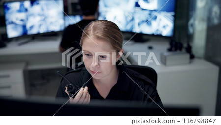 CCTV, radio and security with woman in control room for law enforcement or surveillance. Communication, safety and talking with police officer at police headquarters for crime, inspection or privacy 116298847