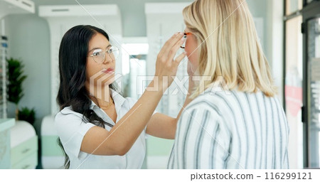 Vision, optometrist and help client with glasses for eye health, wellness or care. Ophthalmology, frame and woman fitting spectacles for eyesight correction or choice of customer with doctor in store 116299121