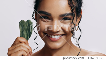 Dermatology, portrait and woman with gua sha stone for wellness, skincare and luxury spa. Body, cosmetics and lady glow with jade crystal, anti aging or natural treatment on white studio background Dermatology, portrait and woman with gua sha stone for wellness, skincare and luxury spa. Body, cosmetics and lady glow with jade crystal, anti aging or natural treatment on white studio background 116299133