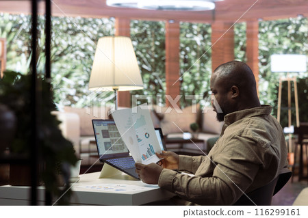 Business owner reviewing key performance indicators within the enterprise activity, remote work at home. Conducting evaluations to help with global expansion plans, finance and economy. Business owner reviewing key performance indicators within the enterprise activity, remote work at home. Conducting evaluations to help with global expansion plans, finance and economy. 116299161