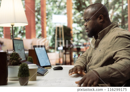 Entrepreneur drafting architectural blueprints for a office space hunt, reviewing property sketch to relocate the small business. Searching buildings for leasing, new workplace interior design. 116299175