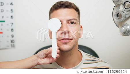 Cover, vision and man in portrait for eye exam, optometrist and test for depth perception in office. Healthcare, insurance and male patient with specialist for health, checkup and wellness at consult Cover, vision and man in portrait for eye exam, optometrist and test for depth perception in office. Healthcare, insurance and male patient with specialist for health, checkup and wellness at consult 116299324
