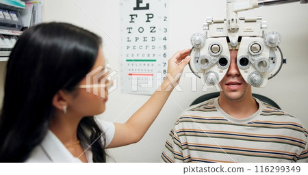 Doctor, ophthalmologist and man on phoropter for eye care, consultation and healthcare exam in clinic. Optometry, test and patient on lens machine for vision check, wellness and eyesight correction 116299349