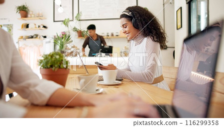 Woman, cafe and reading with phone and headphones, streaming service or music for productivity. Female person, laptop and mobile technology for podcast listening, online with smile for remote work 116299358