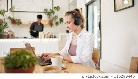 Laptop, cafe and woman with remote work, writing and headphones for social media blog post. Typing, music and website update of a web designer working at a restaurant and coffee shop with drink 116299440