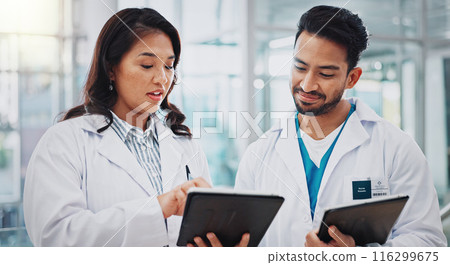 Doctors, man and woman with tablet, discussion or check results for medical services at hospital. People, happy and digital touchscreen in clinical study, review and feedback at clinic in Indonesia 116299675
