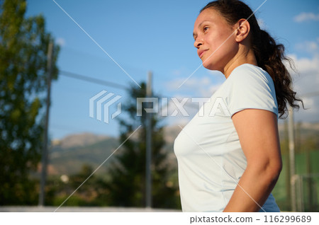 Confident woman exercising outdoors on a sunny day 116299689
