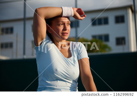 Woman resting after outdoor workout on a sunny day 116299692