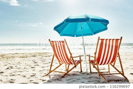 Rest, relax and beach chairs with umbrella on sand for vacation, holiday or weekend break. Summer, blue sky and seats in nature with ocean water for peace, travel or tourism in bali getaway 116299697