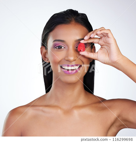 Raspberry, eye and woman in studio for skincare, nutrition and portrait on white background. Indian girl, fruit and smile with cosmetics for aesthetic, treatment and wellness or luxury and makeup Raspberry, eye and woman in studio for skincare, nutrition and portrait on white background. Indian girl, fruit and smile with cosmetics for aesthetic, treatment and wellness or luxury and makeup 116299698