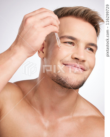 Cosmetics, man and liquid serum on face for skincare, wellness and hygiene in studio white background. Male person, health product and dermatology grooming for collagen treatment or essential oil 116299729