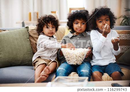 Children, watching tv and eating popcorn on sofa in living room, home and streaming cartoon movie for entertainment on holiday. Boys, family and together for video subscription with childhood film 116299743