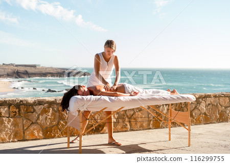 Masseur massaging female outdoor full length 116299755