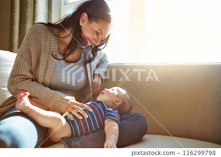 Baby, mother and bonding in living room on sofa with love for relationship with new born, care and embrace. Light, sunshine and relax with smile, happiness and playing on couch with child in house. Baby, mother and bonding in living room on sofa with love for relationship with new born, care and embrace. Light, sunshine and relax with smile, happiness and playing on couch with child in house. 116299798
