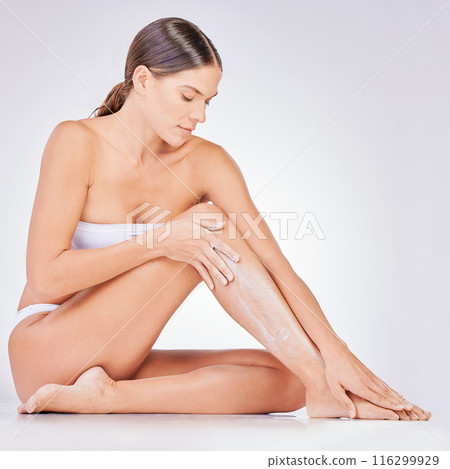 Hair removal, skincare and woman with shaving cream in studio for natural cosmetic, epilation or grooming. Body, legs and model on floor for treatment, wellness or satisfaction on white background. Hair removal, skincare and woman with shaving cream in studio for natural cosmetic, epilation or grooming. Body, legs and model on floor for treatment, wellness or satisfaction on white background. 116299929