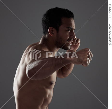 Man, boxer and punch in studio for workout for mma sport, fighter and background or training for challenge or competition fight. Strong, power and exercise for strength, combat fitness and health 116299931