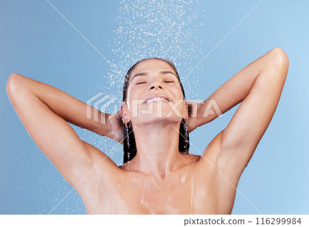 Shower, water and woman washing hair for shampoo, cosmetics and wellness cleaning or conditioner. Female person, happy and rinsing scalp in studio blue background for haircare or morning routine 116299984