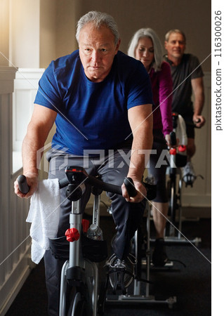 Spin class, mature or man on cycling bike in workout or cardio training for energy, health or wellness. Active, performance or sports person on bicycle machine for fitness, gym challenge or exercise Spin class, mature or man on cycling bike in workout or cardio training for energy, health or wellness. Active, performance or sports person on bicycle machine for fitness, gym challenge or exercise 116300026