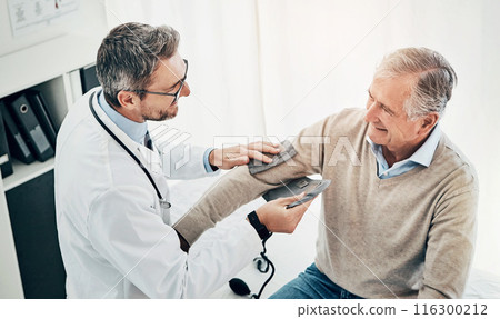 Blood pressure, man and doctor in office with support, help and advice for health insurance. Clinic, senior patient and medical professional at desk with consultation, trust and healthcare at checkup 116300212