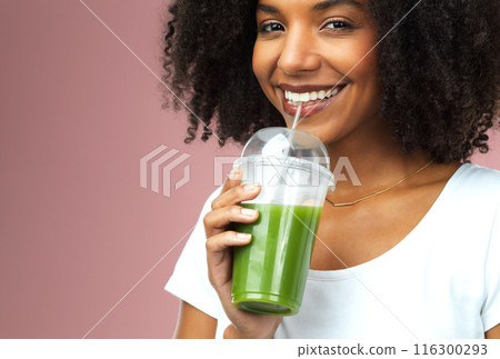 Happy, health and portrait of woman with green juice for detox, nutrition or wellness diet. Smile, confident and female person drinking organic smoothie for vitamins isolated by studio background. Happy, health and portrait of woman with green juice for detox, nutrition or wellness diet. Smile, confident and female person drinking organic smoothie for vitamins isolated by studio background. 116300293