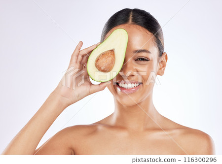 Woman, studio and avocado with natural beauty for skincare with sustainability, fruit oil with cosmetics. Female person, white background and plant based for makeup, portrait with smile for wellness Woman, studio and avocado with natural beauty for skincare with sustainability, fruit oil with cosmetics. Female person, white background and plant based for makeup, portrait with smile for wellness 116300296
