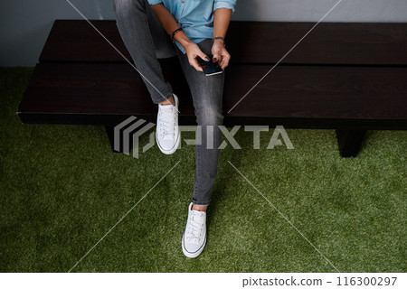 Feet, hands and mobile screen for online chat, communication and reading email of study opportunity. Bench, person or student relax with phone app for news, campus FAQ or college registration above 116300297