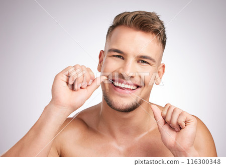 Dental floss, portrait and man in studio for teeth cleaning, self care and morning routine on white background. Oral hygiene, confidence and model for wellness, fresh breath and healthy mouth. 116300348