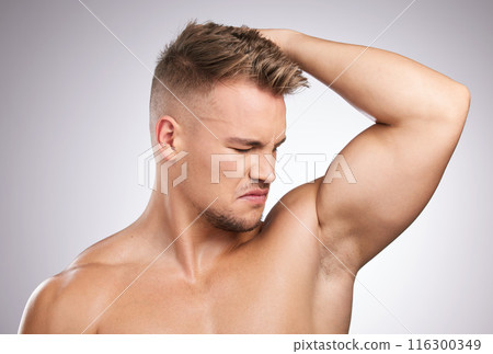 Man, smelling and armpit in studio for health, cleaning and wellness or body oudor. Male person, skincare and hygiene in bathroom for cosmetics, perfume and antiperspirant by white background 116300349