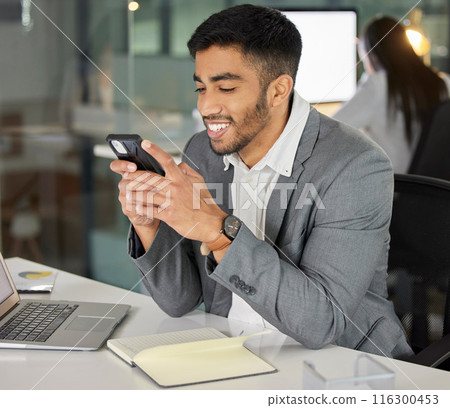 Young businessman, phone and social media in office for chat, email and online research at desk. Happy consultant, networking and mobile app in workplace for lunch break, internet and communication 116300453