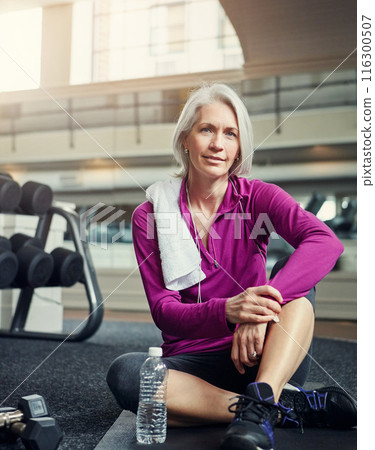 Mature woman, portrait and water on gym floor for break, hydration or tired from workout for wellness. Person, bottle and relax on mat with pride, fatigue and smile for training, exercise and fitness Mature woman, portrait and water on gym floor for break, hydration or tired from workout for wellness. Person, bottle and relax on mat with pride, fatigue and smile for training, exercise and fitness 116300507