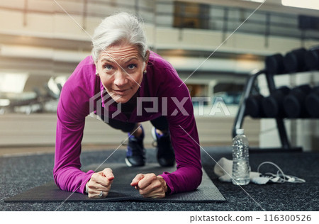 Mature woman, plank and gym on floor with balance for strong core muscle with vision for wellness. Person, training and workout for abdomen, stomach and challenge for development at fitness club 116300526