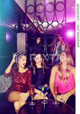 Women, friends in nightclub and laughing with cocktails or drinks for vip event or reunion. Funny joke, relax or happy people in dark disco party couch for fashion, alcohol or social celebration 116300589