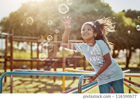 Soap, bubbles and girl with playground, fun and love for summer break and play. Kid, childhood and park equipment for joy, outside nature and happy child smile with countryside merry go round 116300677