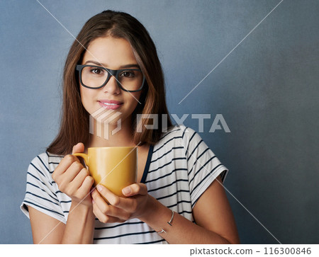 Woman, student and coffee in studio with portrait, drink and glasses on blue background. Smile, caffeine and hot chocolate for female person, hands and matcha latte or green tea for relax or break 116300846