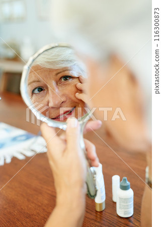 Home, mirror and elderly woman for skincare, checking and face inspection with hand gesture. Reflection, mature person and beauty treatment for wrinkles, anti aging and skin texture in house 116300873